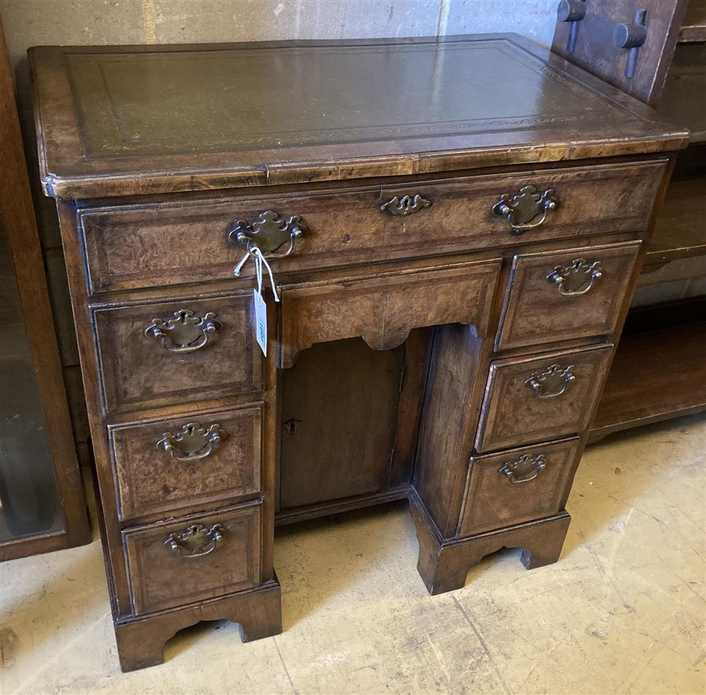 A Queen Anne style walnut kneehole desk, width 74cm, depth 44cm, height 77cm